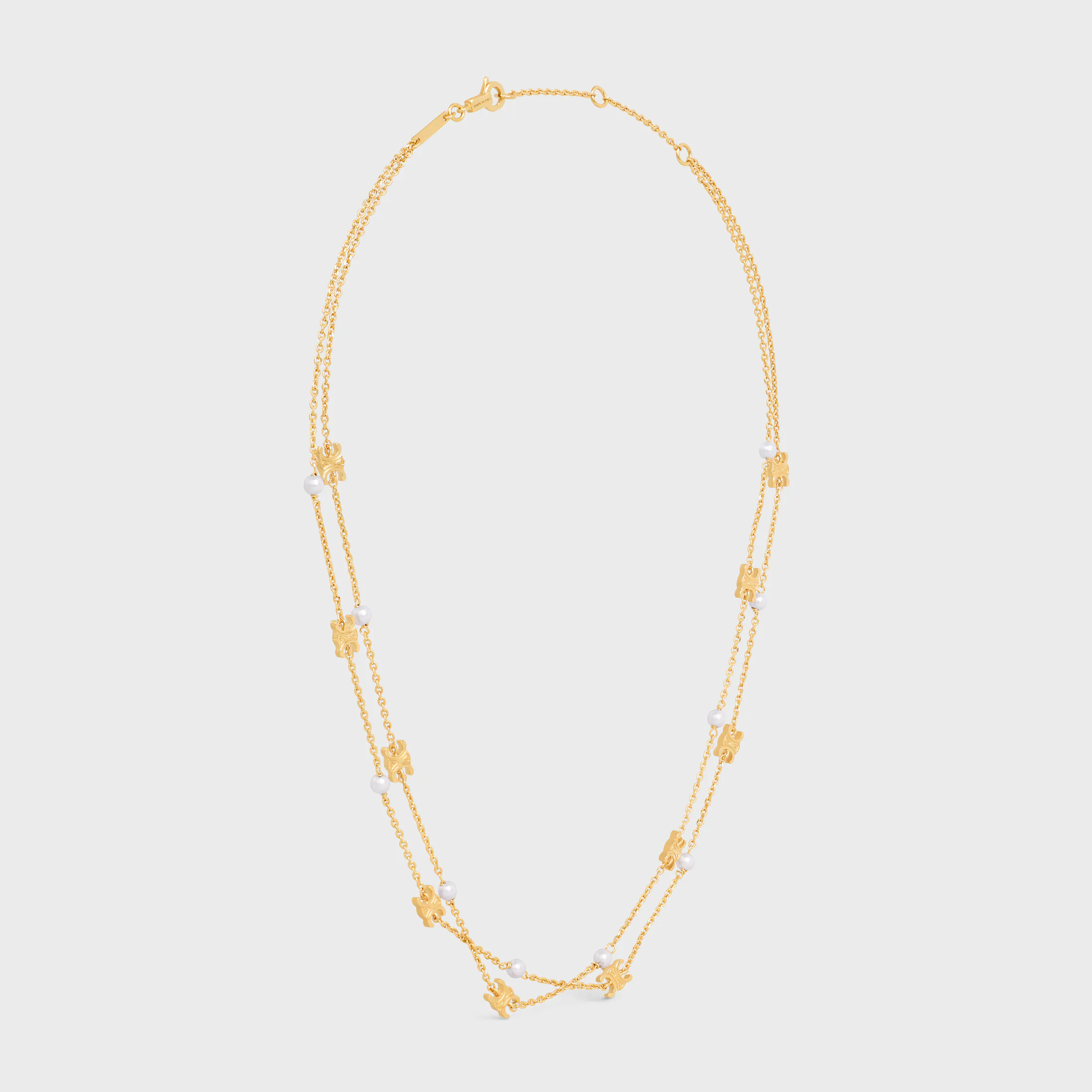 Triomphe Pearl dubbel halsband i blankt brons med gyllene beläggning och resinperlor