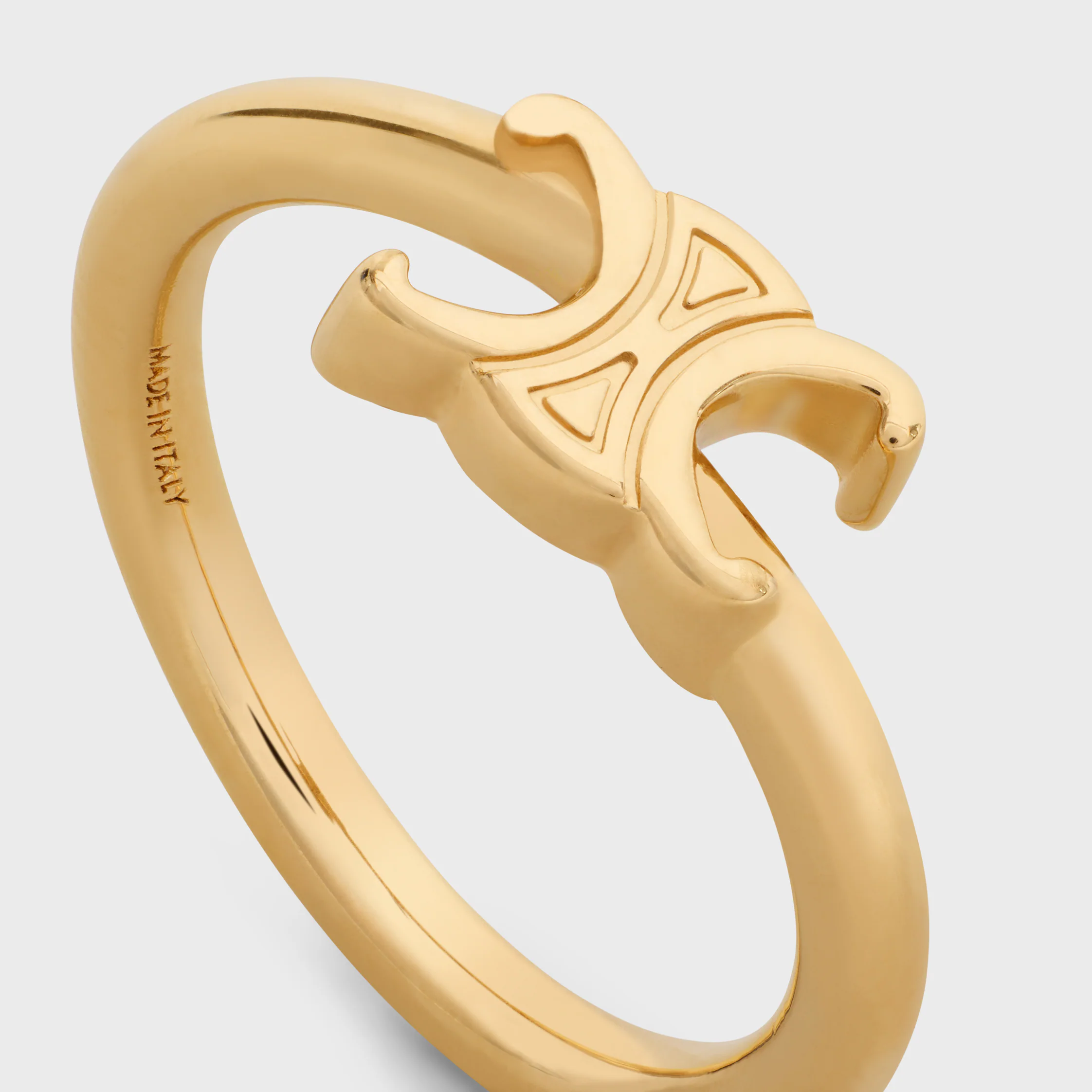 Triomphe-osymmetrisk ring i blankt brons med gyllene beläggning
