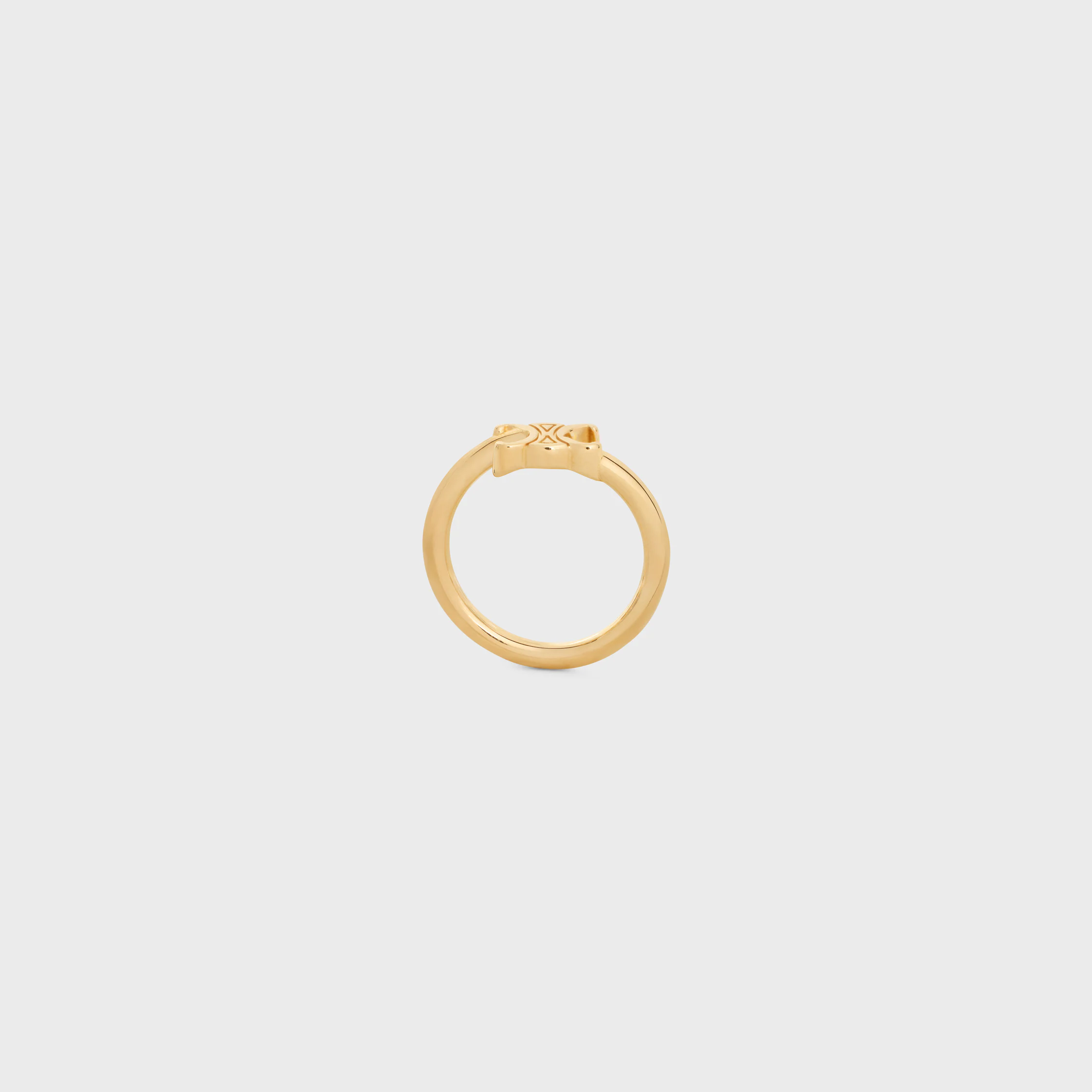 Triomphe-osymmetrisk ring i blankt brons med gyllene beläggning